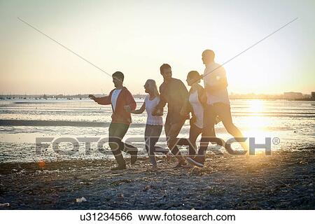 Group of friends having fun on beach View Large Photo Image Stock Photograph - Group of friends having fun on beach. Fotosearch