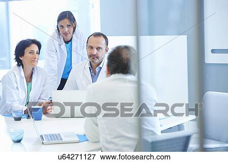 Stock Photo - Group of researchers having meeting. Fotosearch