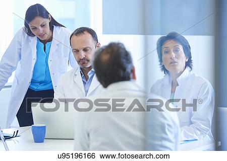 Stock Photograph - Group of researchers having meeting. Fotosearch