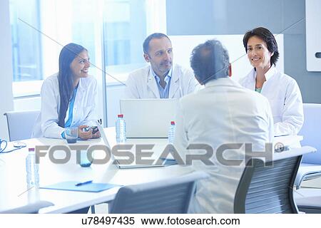 Stock Photography - Group of researchers having meeting. Fotosearch