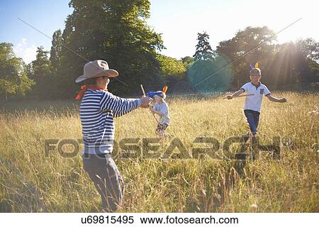 Group of young boys playing in a field View Large Photo Image Stock Photography - Group of young boys playing in a field. Fotosearch
