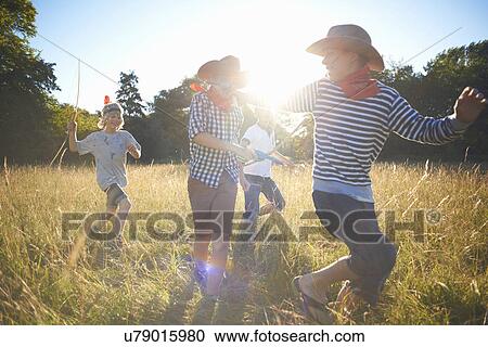 Group of young boys playing in field View Large Photo Image Stock Image - Group of young boys playing in field. Fotosearch