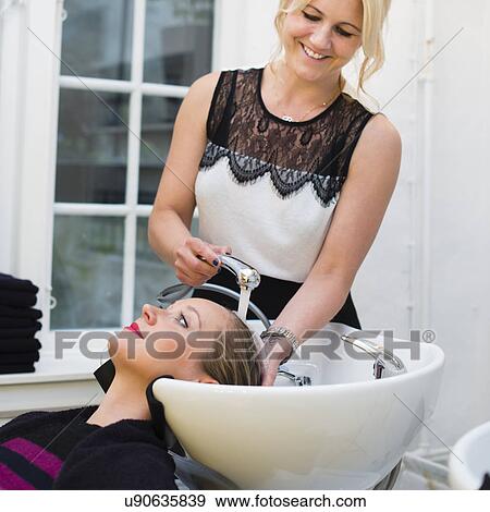 Hairdresser washing customer's hair View Large Photo Image Stock Photo - Hairdresser washing customer's hair. Fotosearch