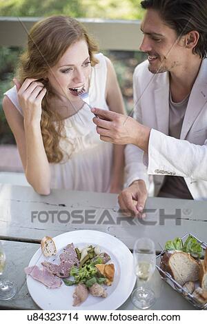 High angle view of couple eating lunch in garden restaurant View Large Photo Image Picture - High angle view of couple eating lunch in garden restaurant. Fotosearch