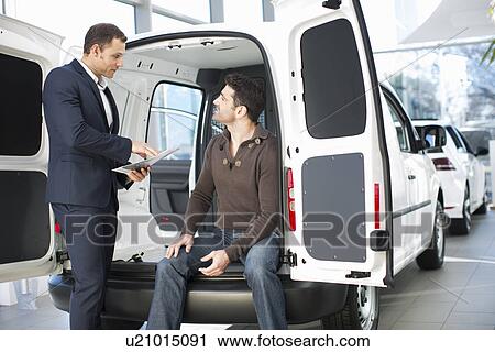 Indecisive customer and salesman in car dealership View Large Photo Image Stock Image - Indecisive customer and salesman in car dealership. Fotosearch