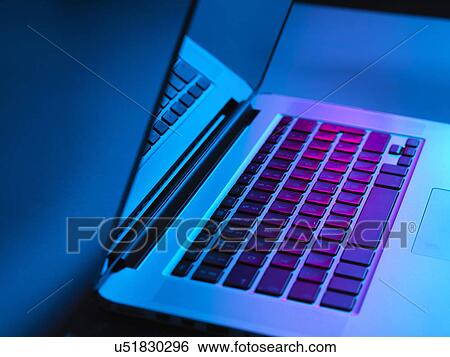 Laptop on office desk at night View Large Photo Image Stock Photograph - Laptop on office desk at night. Fotosearch