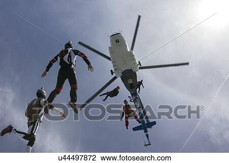 Low angle view of helicopter and six skydivers free falling, Siofok, Somogy, Hungary View Large Photo Image Stock Image - Low angle view of helicopter and six skydivers free falling, Siofok, Somogy, Hungary. Fotosearch