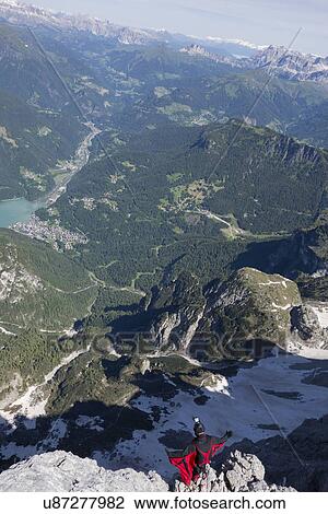 Male BASE jumper on mountain edge, Alleghe, Dolomites, Italy View Large Photo Image Stock Image - Male BASE jumper on mountain edge, Alleghe, Dolomites, Italy. Fotosearch