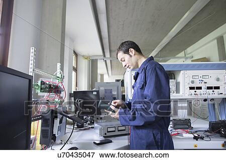 Male electrician repairing control panel in workshop View Large Photo Image Stock Photo - Male electrician repairing control panel in workshop. Fotosearch