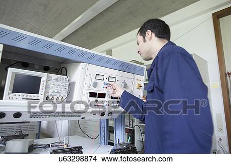 Male electrician testing control panel in workshop View Large Photo Image Picture - Male electrician testing control panel in workshop. Fotosearch