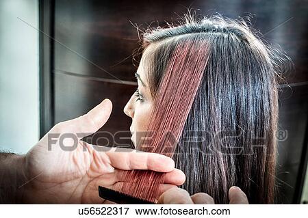 Male hairdresser combing young woman's hair in hair salon View Large Photo Image Stock Photo - Male hairdresser combing young woman's hair in hair salon. Fotosearch