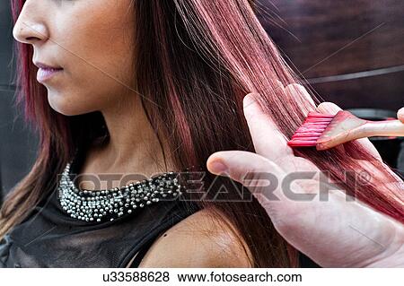 Male hairdresser dyeing young woman's hair pink color in hair salon View Large Photo Image Stock Photo - Male hairdresser dyeing young woman's hair pink color in hair salon. Fotosearch