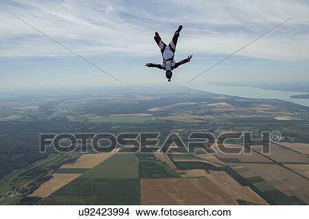Male skydiver freeflying upside down above Siofok, Somogy, Hungary View Large Photo Image Picture - Male skydiver freeflying upside down above Siofok, Somogy, Hungary. Fotosearch
