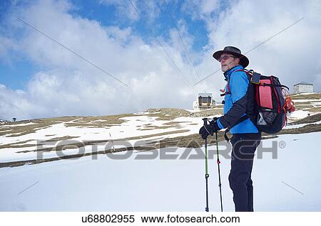 Stock Photography - Mature man with hiking poles, Bucegi Mountains, Transylvania, Romania. Fotosearch