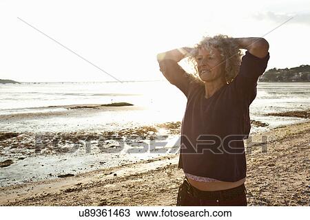 Mature woman enjoying beach View Large Photo Image Stock Image - Mature woman enjoying beach. Fotosearch