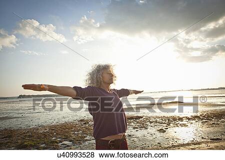 Mature woman exercising on beach View Large Photo Image Stock Photo - Mature woman exercising on beach. Fotosearch