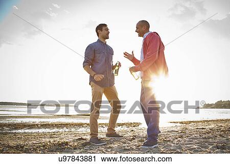 Men drinking beer and chatting on beach View Large Photo Image Stock Image - Men drinking beer and chatting on beach. Fotosearch