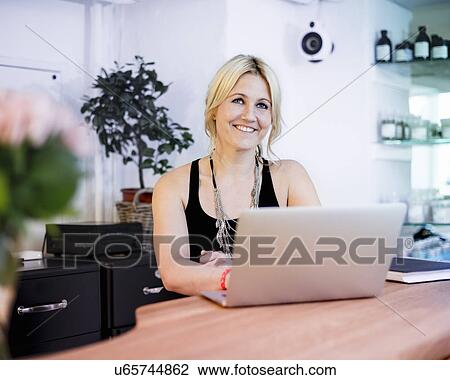 Mid adult woman using laptop View Large Photo Image Stock Image - Mid adult woman using laptop. Fotosearch