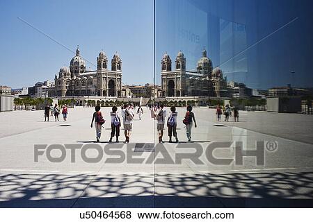 Stock Photo - Mirror reflection of tourists and Marseille cathedral, Marseille, France. Fotosearch