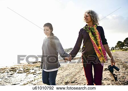 Stock Image - Mother and daughter enjoying beach. Fotosearch