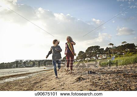 Mother and daughter enjoying beach View Large Photo Image Stock Image - Mother and daughter enjoying beach. Fotosearch