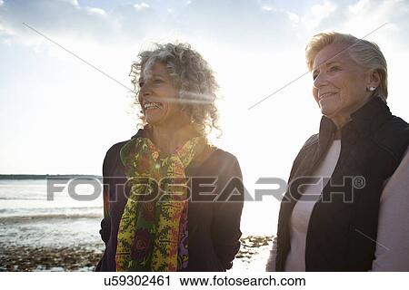 Mother and daughter enjoying view on beach View Large Photo Image Stock Image - Mother and daughter enjoying view on beach. Fotosearch