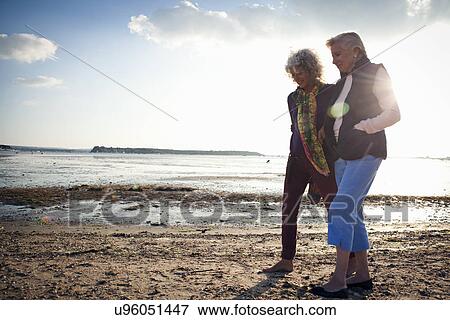 Stock Photo - Mother and daughter walking on beach. Fotosearch