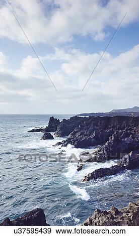 Ocean waves and coast, Lanzarote, Canary Islands, Spain View Large Photo Image Stock Photo - Ocean waves and coast, Lanzarote, Canary Islands, Spain. Fotosearch