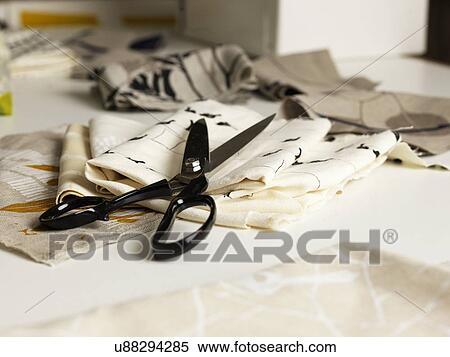 Stock Photography - Pair of scissors and fabric on work table. Fotosearch
