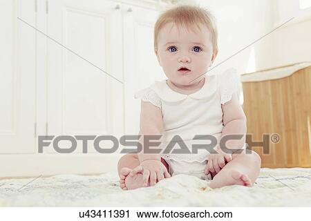 Portrait baby girl sitting on floor View Large Photo Image Stock Image - Portrait baby girl sitting on floor. Fotosearch