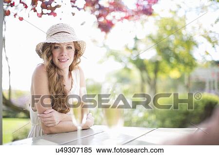 Portrait of beautiful young woman at table in garden restaurant View Large Photo Image Stock Photography - Portrait of beautiful young woman at table in garden restaurant. Fotosearch