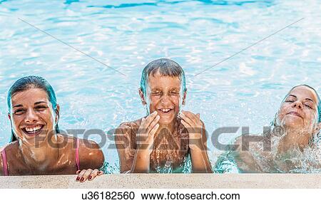 Portrait of boy and two sisters in swimming pool View Large Photo Image Stock Image - Portrait of boy and two sisters in swimming pool. Fotosearch