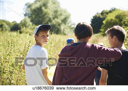 Portrait of boy wearing cap with friends View Large Photo Image Stock Photo - Portrait of boy wearing cap with friends. Fotosearch