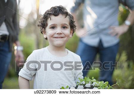 Portrait of boy with plants in egg carton in allotment View Large Photo Image Stock Photo - Portrait of boy with plants in egg carton in allotment. Fotosearch