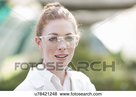 Stock Photo - Portrait of female scientist in poly tunnel. Fotosearch