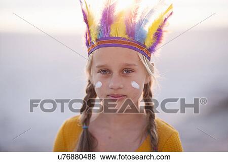 Stock Photo - Portrait of girl dressed as native american with feather headdress. Fotosearch