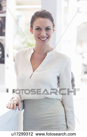 Portrait of saleswoman in car dealership View Large Photo Image Stock Image - Portrait of saleswoman in car dealership. Fotosearch