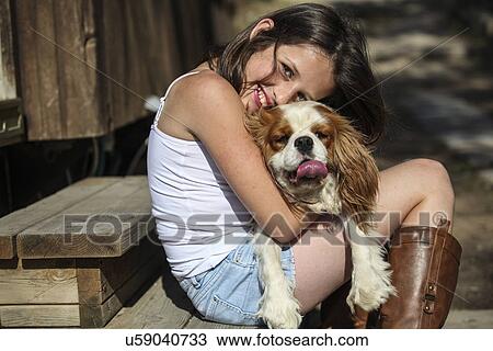 Portrait of smiling girl hugging dog on steps View Large Photo Image Stock Image - Portrait of smiling girl hugging dog on steps. Fotosearch