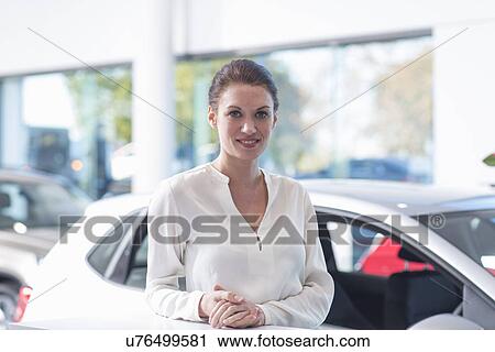 Portrait of smiling saleswoman in car dealership View Large Photo Image Stock Image - Portrait of smiling saleswoman in car dealership. Fotosearch