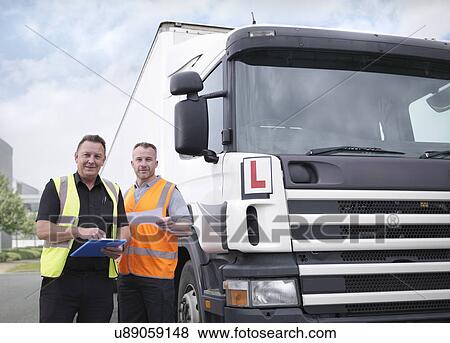 Portrait of trainee truck driver receiving pass certificate from instructor View Large Photo Image Stock Photo - Portrait of trainee truck driver receiving pass certificate from instructor. Fotosearch