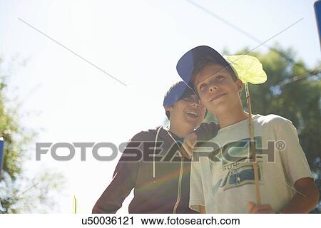 Portrait of two boys, one with fishing net View Large Photo Image Stock Image - Portrait of two boys, one with fishing net. Fotosearch