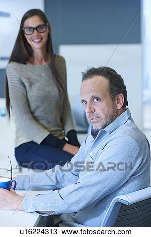 Stock Image - Portrait of two business people. Fotosearch