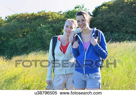 Portrait of two young women in field View Large Photo Image Stock Photography - Portrait of two young women in field. Fotosearch