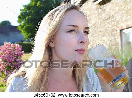 Portrait of young woman holding glass View Large Photo Image Stock Image - Portrait of young woman holding glass. Fotosearch