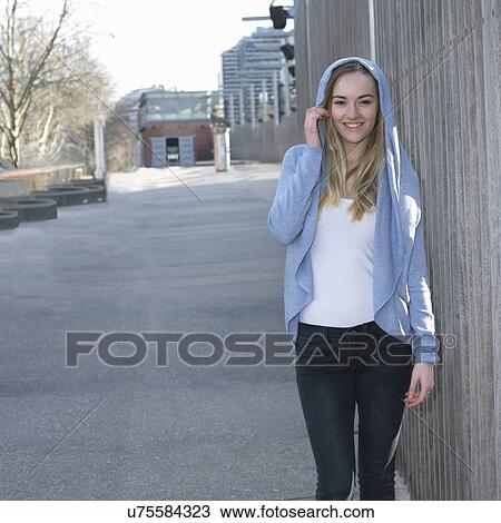 Portrait of young woman wearing hooded top View Large Photo Image Stock Image - Portrait of young woman wearing hooded top. Fotosearch