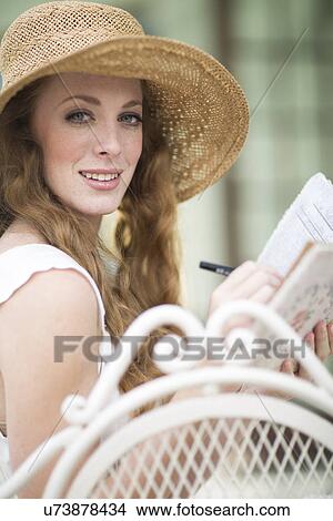 Picture - Portrait of young woman writing. Fotosearch