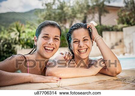 Picture - Portrait of young women in swimming pool, Capoterra, Sardinia, Italy. Fotosearch