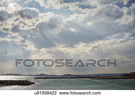 Stock Image - Sea, storm clouds and sunbeams, Marseille, France. Fotosearch