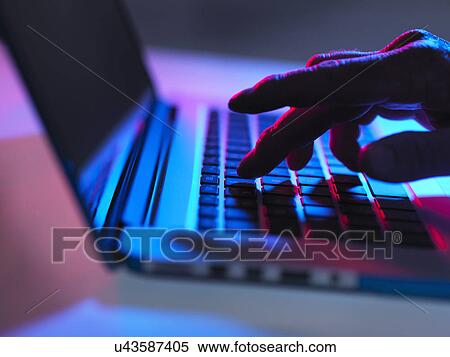 Silhouette of male hand typing on laptop keyboard at night View Large Photo Image Stock Photography - Silhouette of male hand typing on laptop keyboard at night. Fotosearch