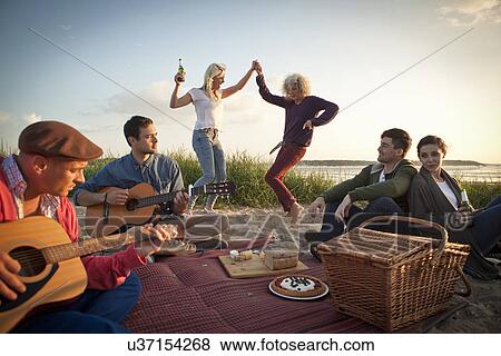 Six adult friends partying and dancing on Bournemouth beach, Dorset, UK View Large Photo Image Stock Photo - Six adult friends partying and dancing on Bournemouth beach, Dorset, UK. Fotosearch